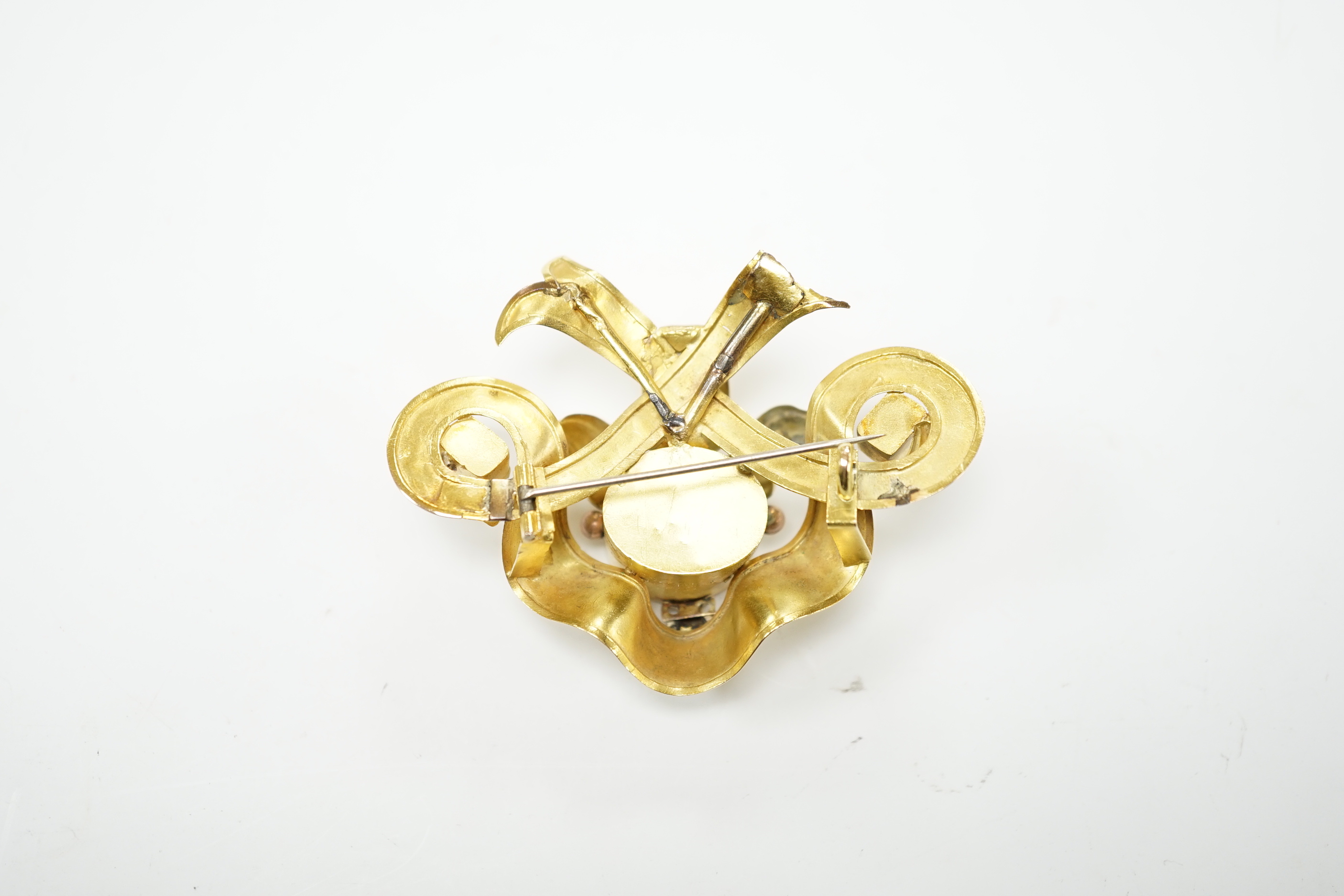 A Victorian engraved yellow metal and foil backed rock crystal and green stone set brooch, width 67mm, gross weight 16.8 grams (a.f.)